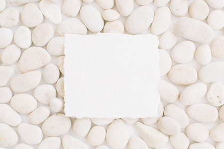 Blank with copy space on neutral pattern of beige stones. Flat lay, top viewの写真素材