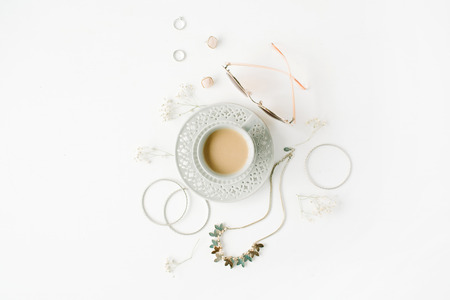 morning breakfast with cup of coffee with milk and trendy fashion accessories arrangement on white, flat lay, top viewの写真素材