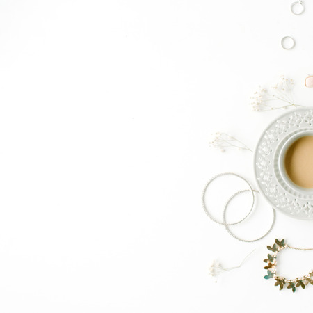 morning breakfast with cup of coffee with milk and trendy fashion accessories arrangement on white, flat lay, top viewの写真素材