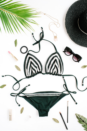 female summer bikini swimsuit accessories collage on white with hat, green branches, necklace and sunglasses. flat lay, top viewの写真素材