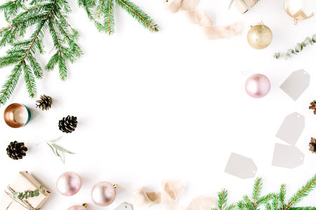 Christmas composition. Frame with fir branches, pine cones, christmas balls, ribbon and tinsel. Flat lay, top viewの写真素材