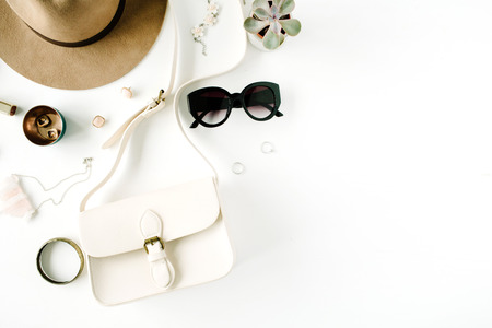Flat lay trendy creative feminine accessories arrangement. Purse, hat, sunglasses, female accessories. Top viewの写真素材