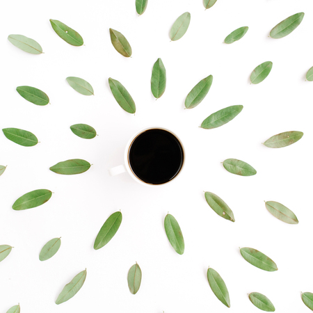 black coffee cup and floral pattern with green petals. flat lay, top viewの写真素材