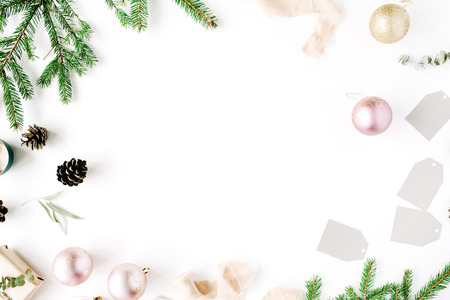 Christmas composition. Frame with fir branches, pine cones, christmas balls, ribbon and tinsel. Flat lay, top viewの写真素材