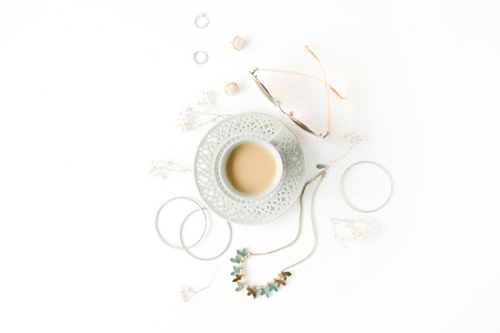 morning breakfast with cup of coffee with milk and trendy fashion accessories arrangement on white, flat lay, top viewの写真素材