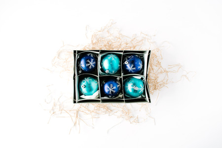 box with bright blue christmas balls on white background. flat lay, top viewの写真素材