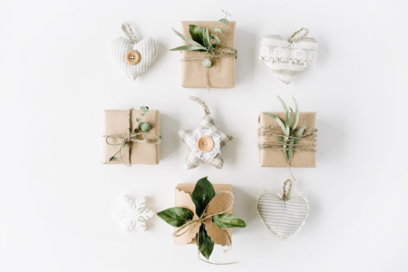 creative arrangement of handmade knitted christmas toys and craft boxes on white background. flat lay, top viewの写真素材