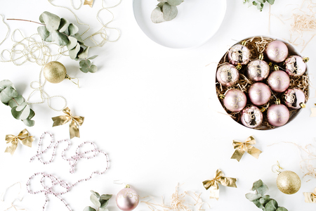 frame made of christmas decoration with christmas glass balls, tinsel, bow, eucalyptus. christmas wallpaper. flat lay, top viewの写真素材