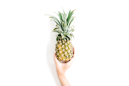 girl's hand holding pineapple. flat lat, top viewの写真素材
