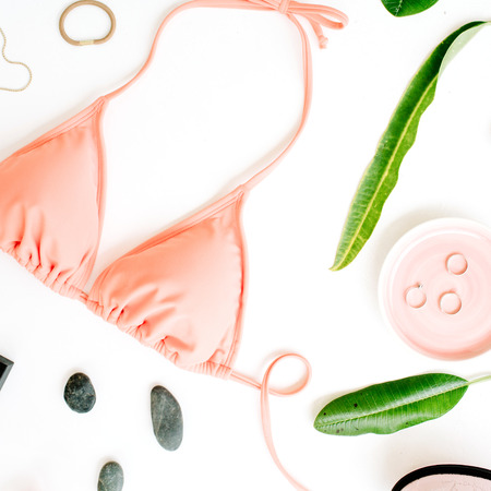 female summer bikini swimsuit and accessories collage on white with palm branches, necklace and lipstick. flat lay, top viewの写真素材