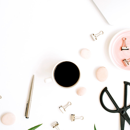 Flat lay, top view office table desk. Workspace with laptop, coffee cup, scissors and clips on white background.の写真素材