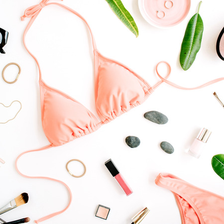 female summer bikini swimsuit and accessories collage on white with palm branches, necklace and sunglasses. flat lay, top viewの写真素材