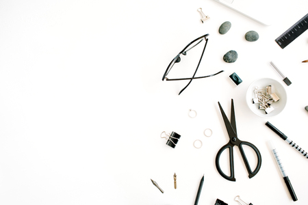 Flat lay, top view office table desk. Workspace with laptop, scissors, glasses, pen on white background.の写真素材