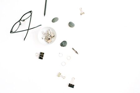 Flat lay, top view office table desk. Feminine accessories with glasses and clipsの写真素材