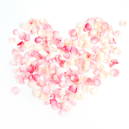 Heart symbol made of pink rose petals. Valentine's day background. Flat lay, top viewの写真素材