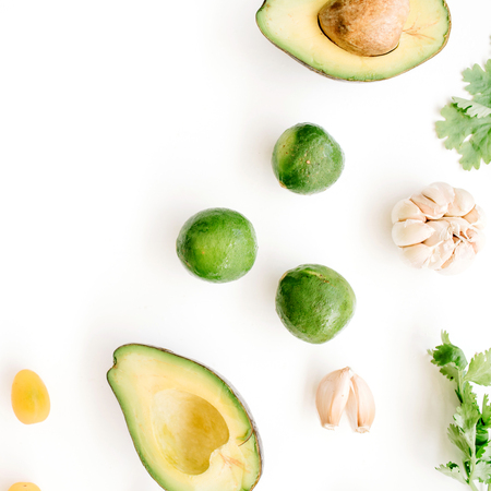 Raw food: avocado, coriander, cherry tomato, lime, garlic. Flat lay, top view. Food concept.の写真素材
