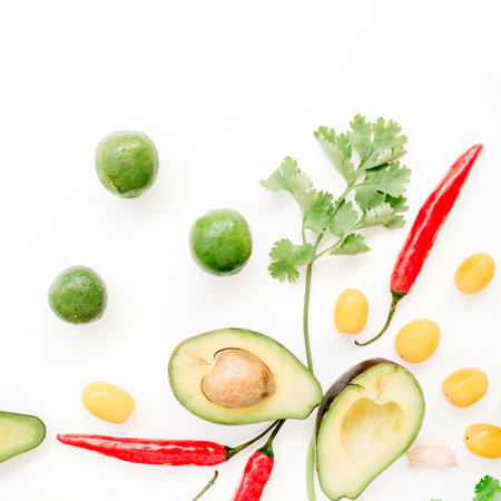 Raw food: avocado, chili pepper, coriander, cherry tomato, lime, garlic. Flat lay, top view. Food concept.の写真素材