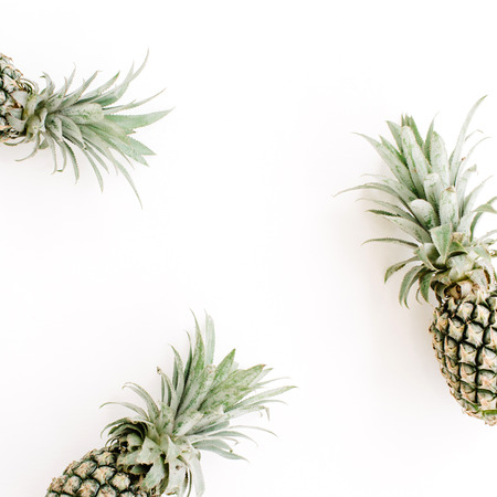 Frame of three pineapples. Flat lay, top view