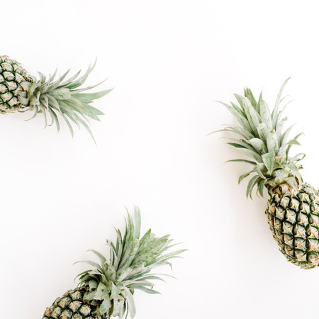 Frame of three pineapples. Flat lay, top view