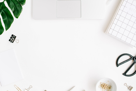 Home office workspace frame with laptop, palm leaf, notebook and accessories. Flat lay, top viewの写真素材