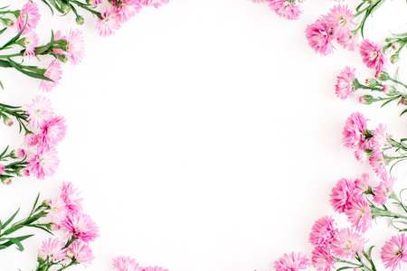 Wreath frame made of pink wildflowers, green leaves, branches on white background. Flat lay, top view. Valentine's backgroundの写真素材