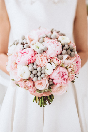 Beauty wedding bouquet in bride's handsの写真素材