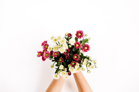 Wildflowers bouquet in girl's hands on white background. Flat lay, top view. Flowers background.の写真素材