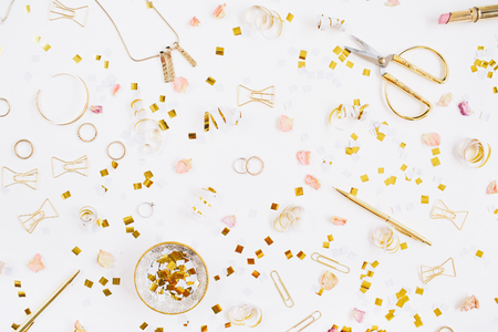 Beauty blog background. Gold style feminine accessories. Golden tinsel, scissors, pen, rings, necklace, bracelet on white background. Flat lay, top view.の写真素材