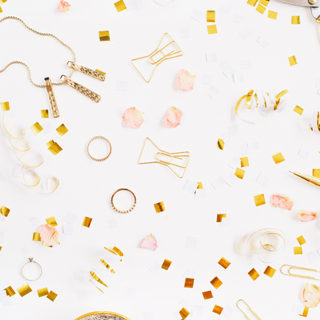 Beauty blog background. Gold style feminine accessories pattern. Golden tinsel, scissors, pen, rings, necklace, bracelet on white background. Flat lay, top view.の写真素材