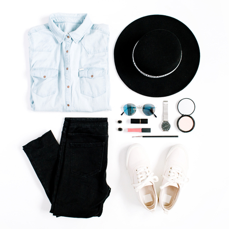 Beauty blog concept. Woman clothes and accessories: hat, jeans, t-shirt, watches, sunglasses, sneakers on white background. Flat lay, top view trendy fashion feminine background.の写真素材