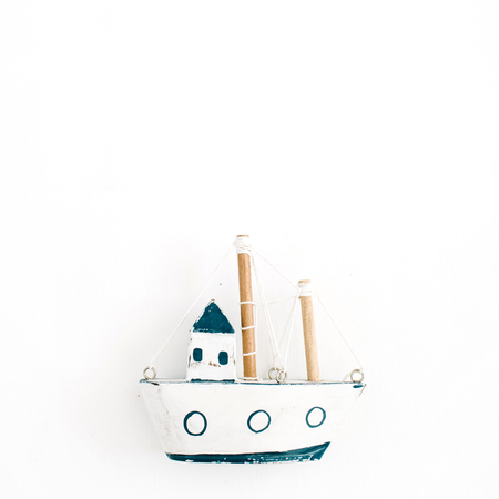 Wooden handmade toy boat on white background. Flat lay, top viewの写真素材