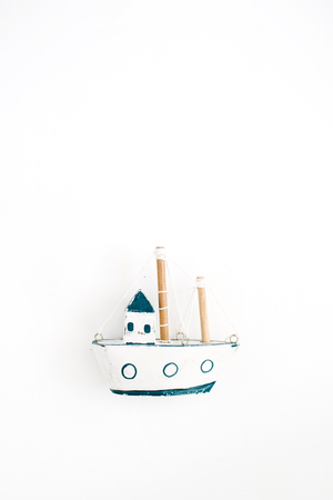 Wooden handmade toy boat on white background. Flat lay, top viewの写真素材
