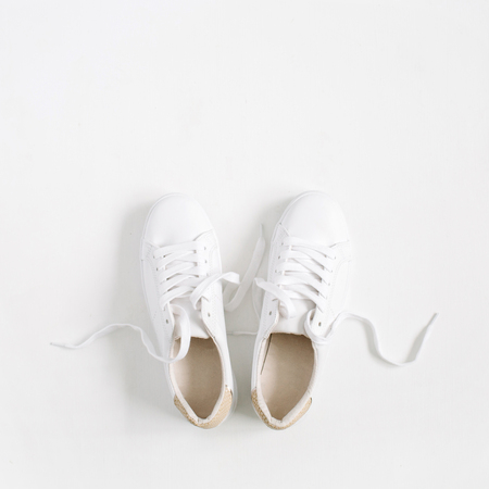 White female sneakers isolated on white background. Flat lay, top viewの写真素材
