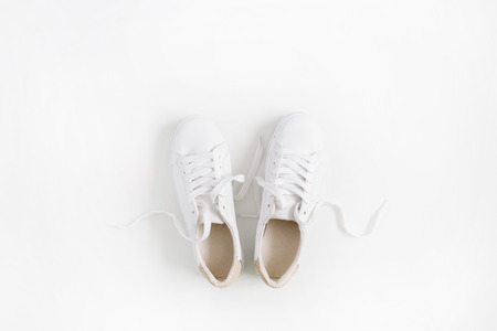 White female sneakers isolated on white background. Flat lay, top viewの写真素材