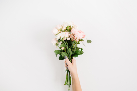 Beautiful pink rose flower bouquet in girls hand isolated on white background. Flat lay, top view. Floral compositionの写真素材
