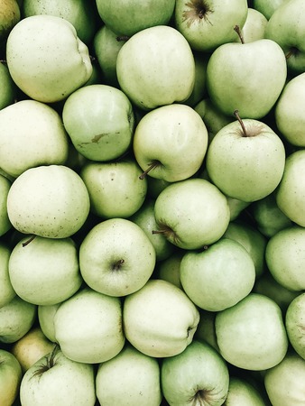 Flat lay raw green apples pattern on white background. Top view minimal concept.の写真素材
