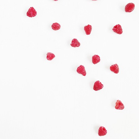 Flat lay raw raspberries pattern on white background. Top view minimal concept.の写真素材