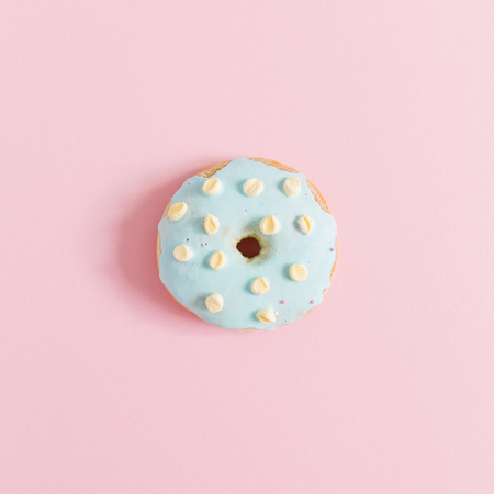 Blue donut on pink background. Minimal flat lay.の写真素材