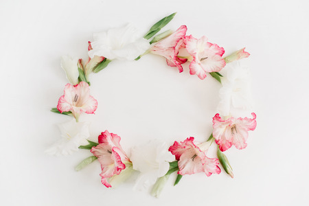 Beautiful pink gladiolus flower frame on white background. Flat lay, top view.の写真素材