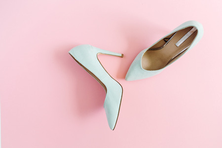 Fashion blog look. Pastel blue women high heel shoes on pink background. Flat lay, top view trendy beauty female background.の写真素材