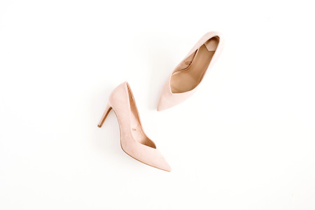 Pale pink women high heel shoes on white background. Flat lay, top view trendy beauty female background.の写真素材