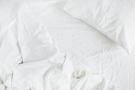 Flat lay of white linen. Top view minimal bed concept.の写真素材