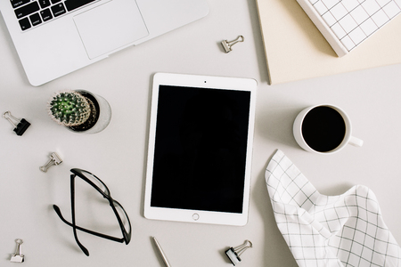 Home office desk with tablet, glasses, coffee mug and stationery. Flat lay, top view business concept.の素材 [FY31087944303]