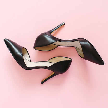 Fashion blog look. Black women high heel shoes on pink background. Flat lay, top view trendy beauty female background.の写真素材