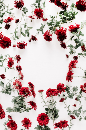 Floral frame made of red flowers on white background. Flat lay, top view. Valentine's background. Flowers concept. の写真素材