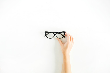 Glasses in woman hand. Minimal flat lay, top view.の写真素材