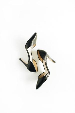 Black female high heels on white background. Flat lay, top view.の写真素材