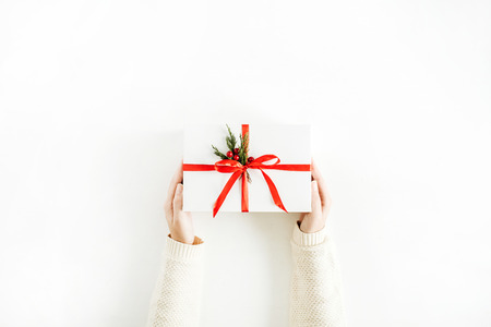 Christmas concept. Women hands holding gift box. Flat lay, top view.
