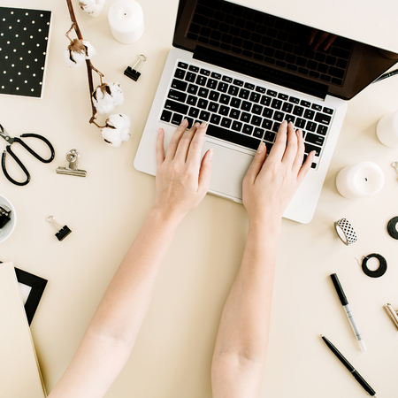 Flat lay home office desk on beige background. Woman working on laptop. Top view female background. Lifestyle blog hero.の写真素材
