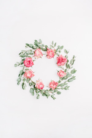 Floral frame wreath made of red rose flowers and eucalyptus branches isolated on white background. Flat lay, top view bridal mockup.の写真素材